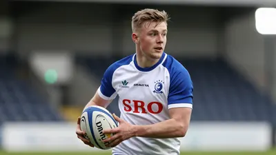 A photorealistic image of an anonymous 25-year-old FC Halifax Town player in a white jersey with blue sleeves and a blue...
