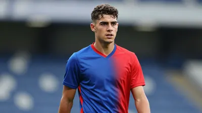 Young academy midfielder, athletic build, early twenties, waist-up, wearing a plain FC Halifax Town home training top...