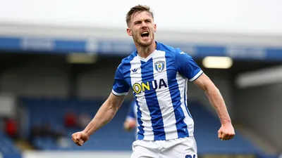 A photorealistic image of an anonymous FC Halifax Town player, wearing a blue and white striped shirt with a white...